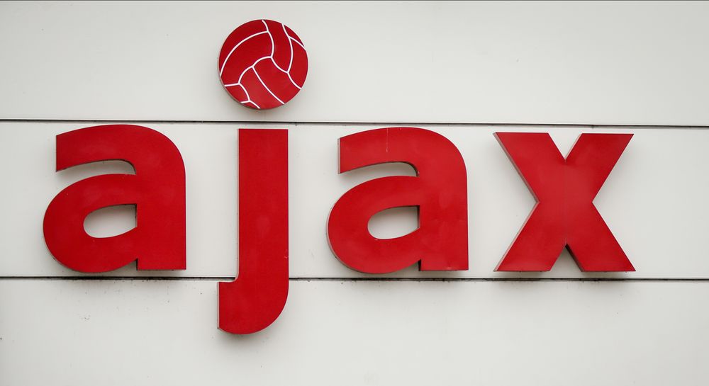 Red Ajax logo on white, featuring a soccer ball for the dot on the 'j'.
