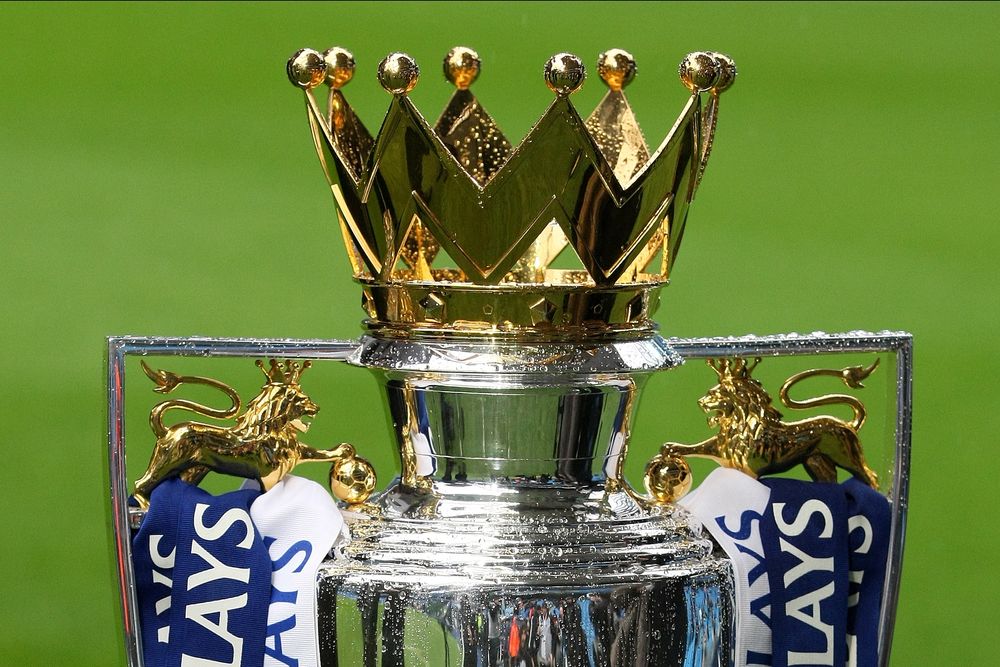 A close-up of the silver Premier League trophy with its golden crown.