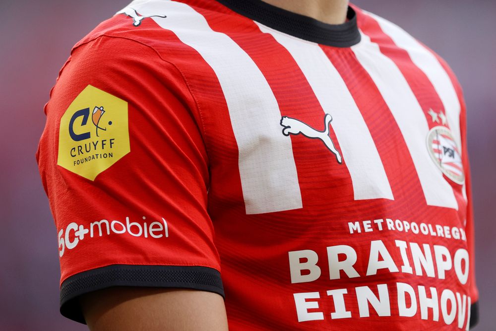 Red and white striped soccer jersey featuring a Cruyff Foundation patch on the sleeve.
