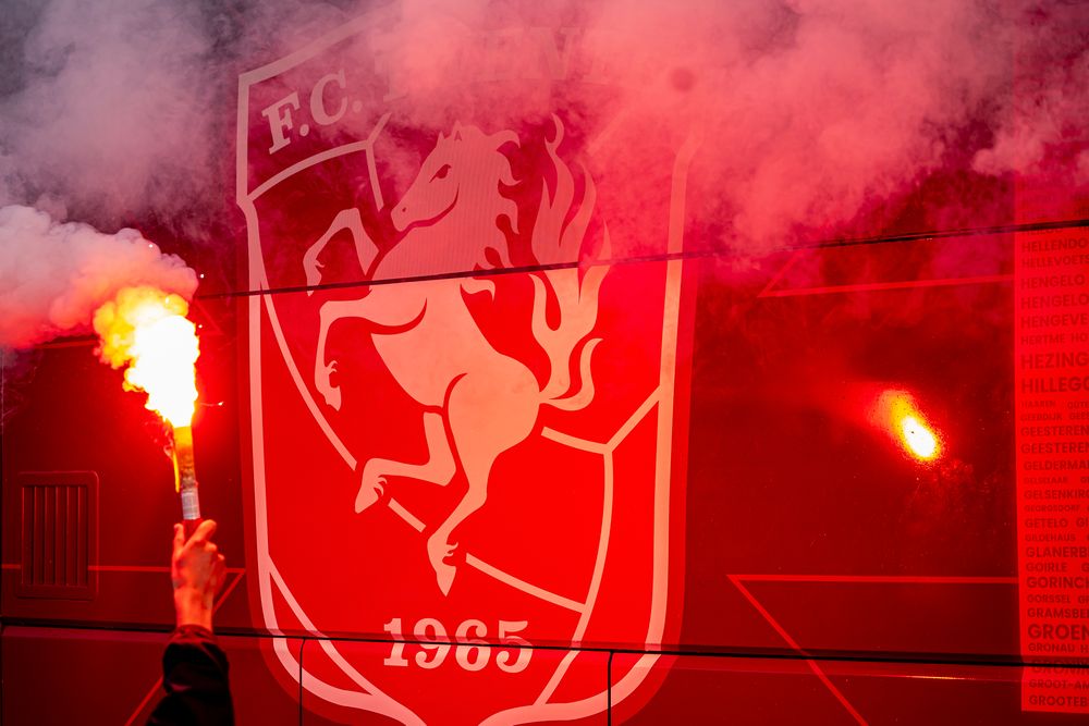 Red smoke flares highlight a shield logo featuring a horse and 'F.C. 1905'.