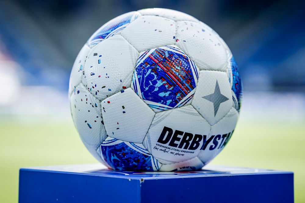 A white and blue Derbystar soccer ball sits on a blue pedestal.