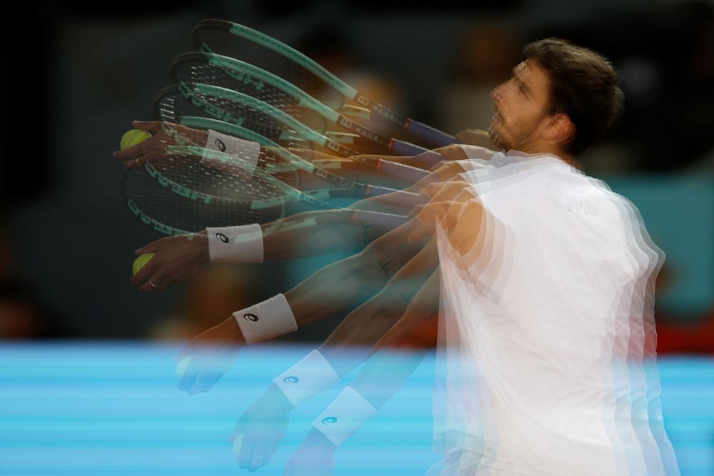 Tennis player serving with multiple exposures showing racket and ball motion.