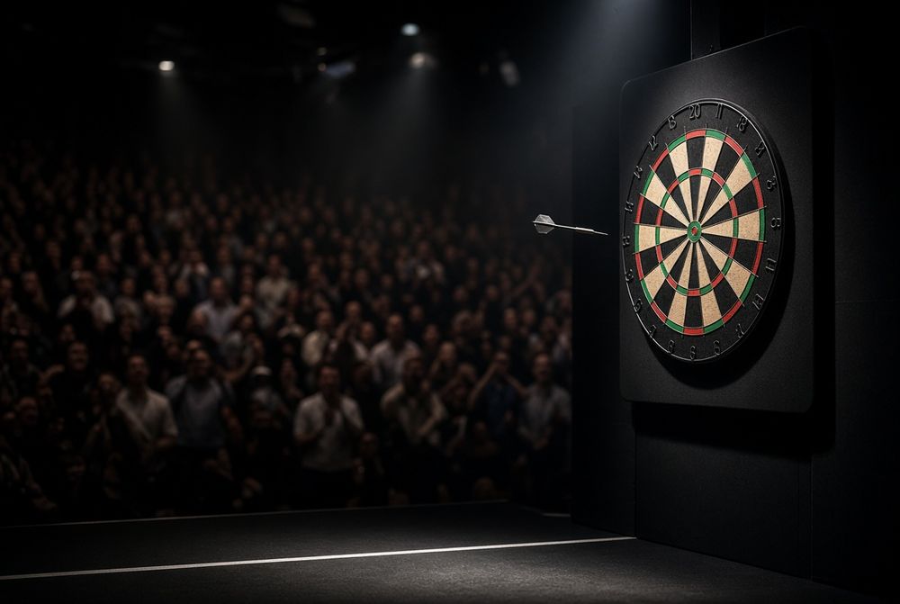 A dart flies towards a dartboard under spotlights, with a blurred, cheering audience visible.