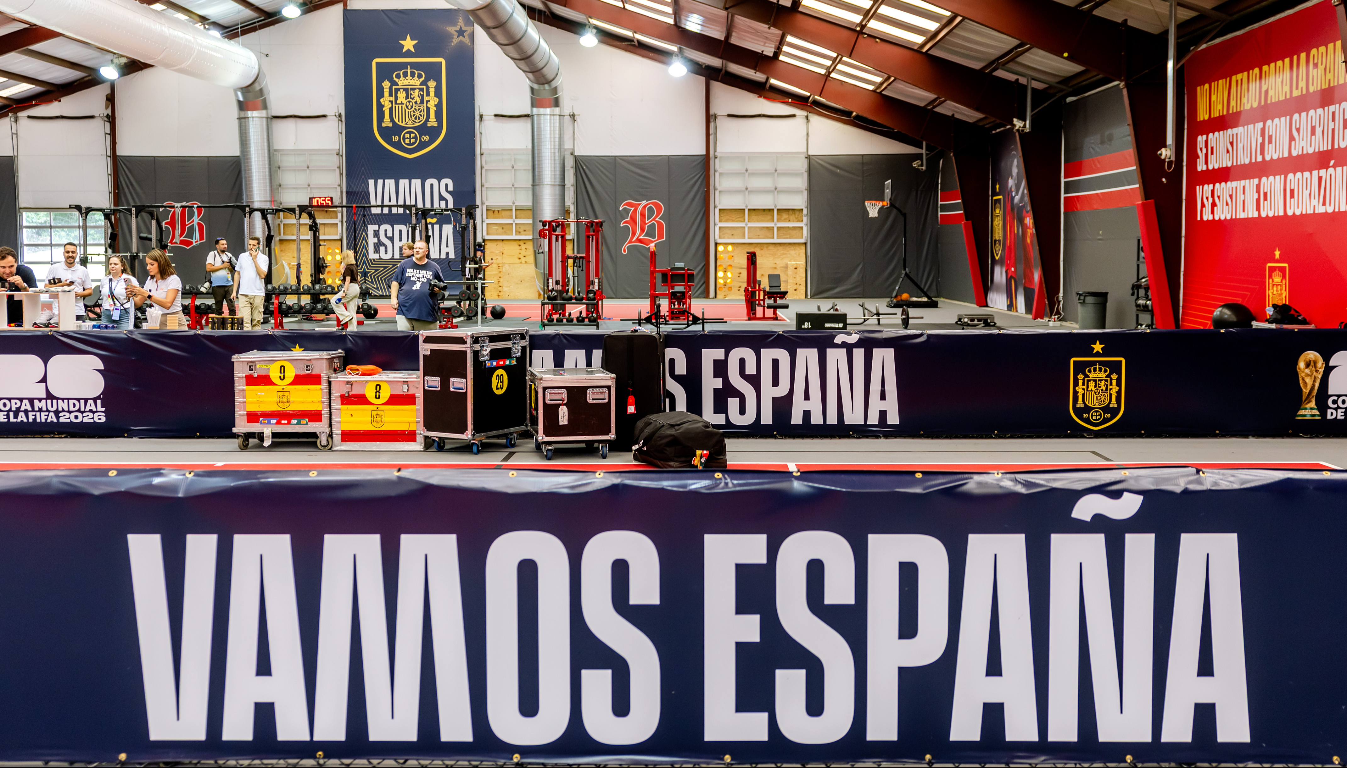 A sports facility with prominent 'VAMOS ESPAÑA' banners and Spanish flag motifs, ready for training.